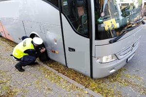 policjant kontroluje autobus