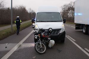 bus i motorower na szosie, z boku widoczny policjant