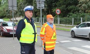 policjant z mężczyzną kierującym ruchem w obrębie szkoły