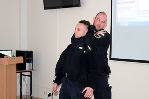 policjanci demonstrują prawidłowa technikę obchwytu szyi