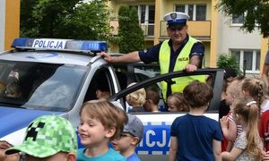 policjant z dziećmi przy radiowozie