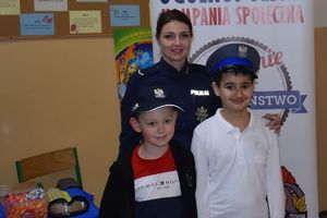 policjantka z uczniami w policyjnych czapkach