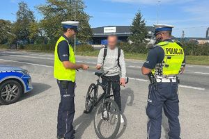 policjanci wręczają odblask rowerzyście